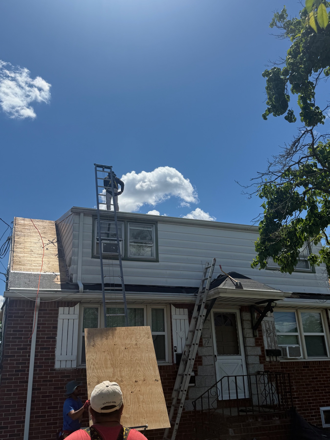 Precision Roofing crew with ladders working a roof replacement on a Clifton, NJ home