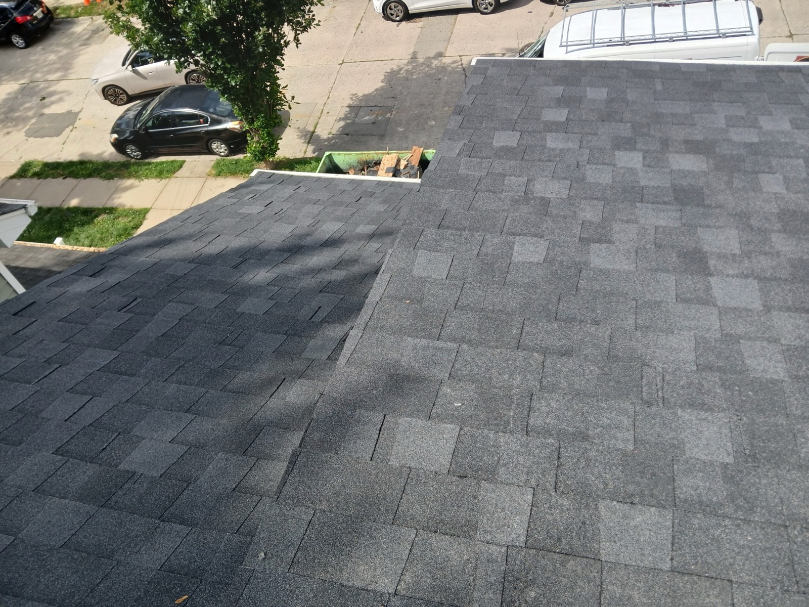 Clean roof valley between two planes of new charcoal architectural shingles in Richwood, NJ