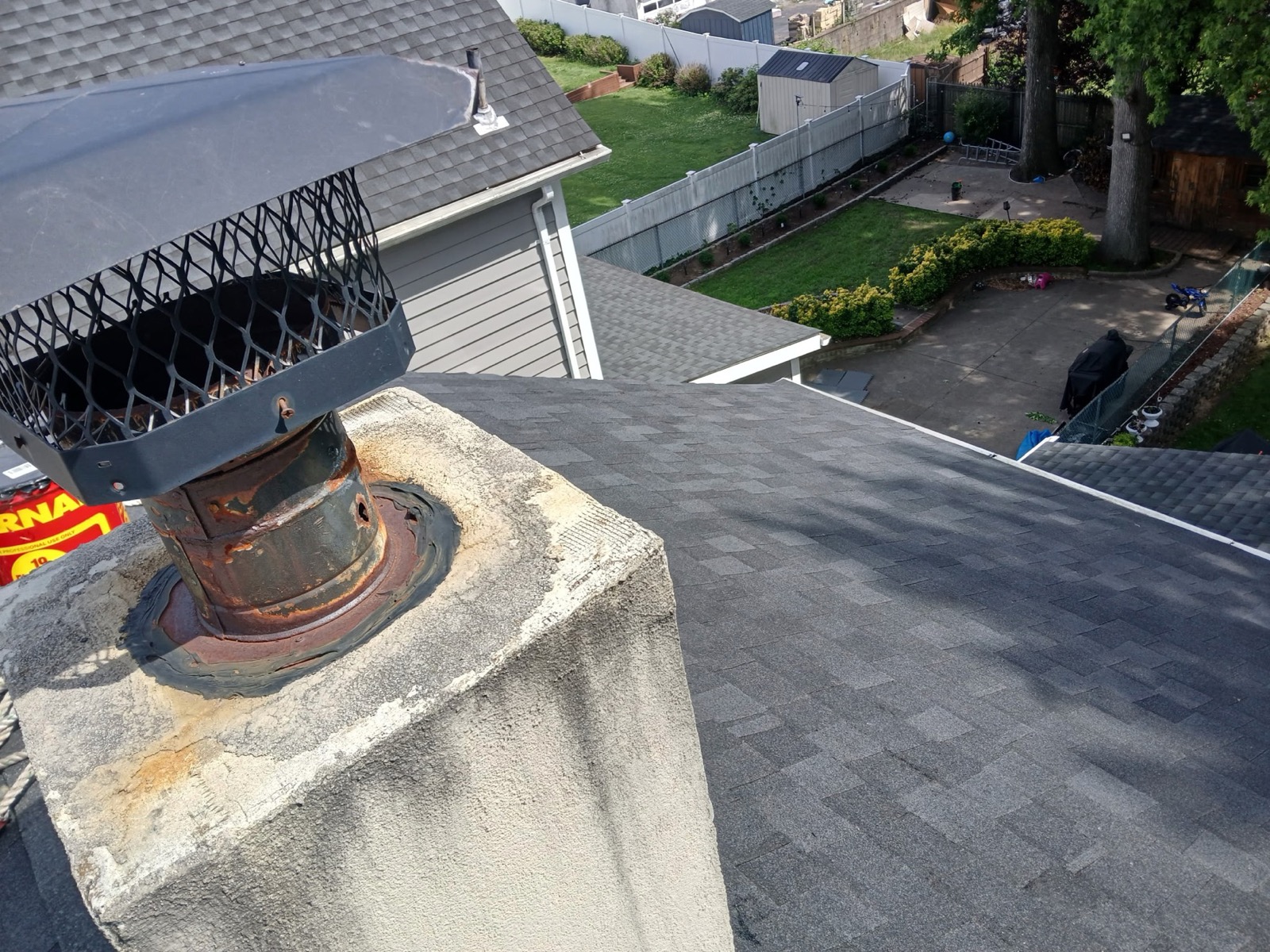 Chimney cap and crown on a completed charcoal architectural shingle roof in Richwood, NJ